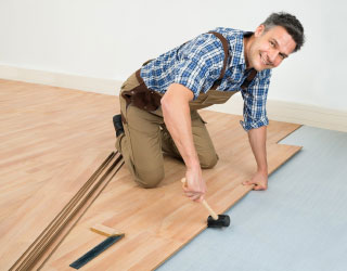man installing hardwood floors