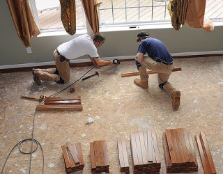 man installing a wood floor