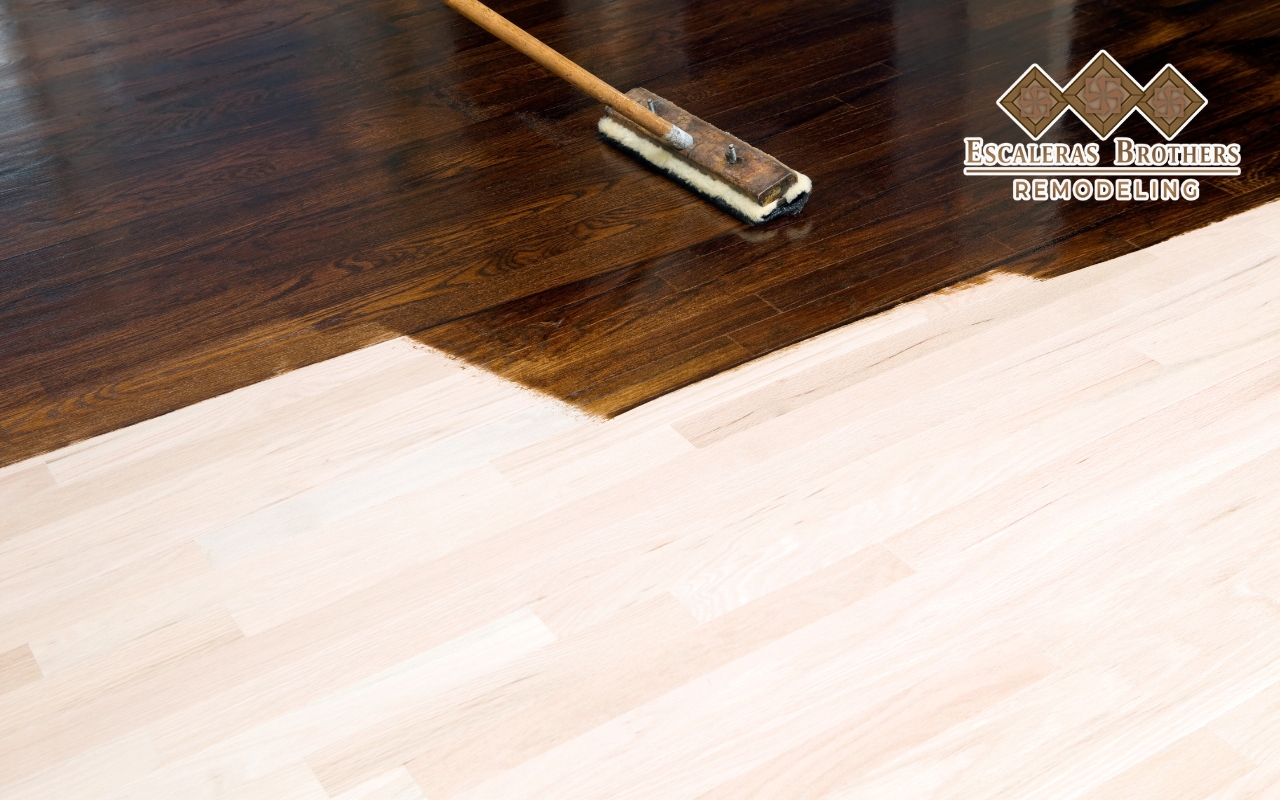 Applying wood stain to hardwood floors for a rich, even color.